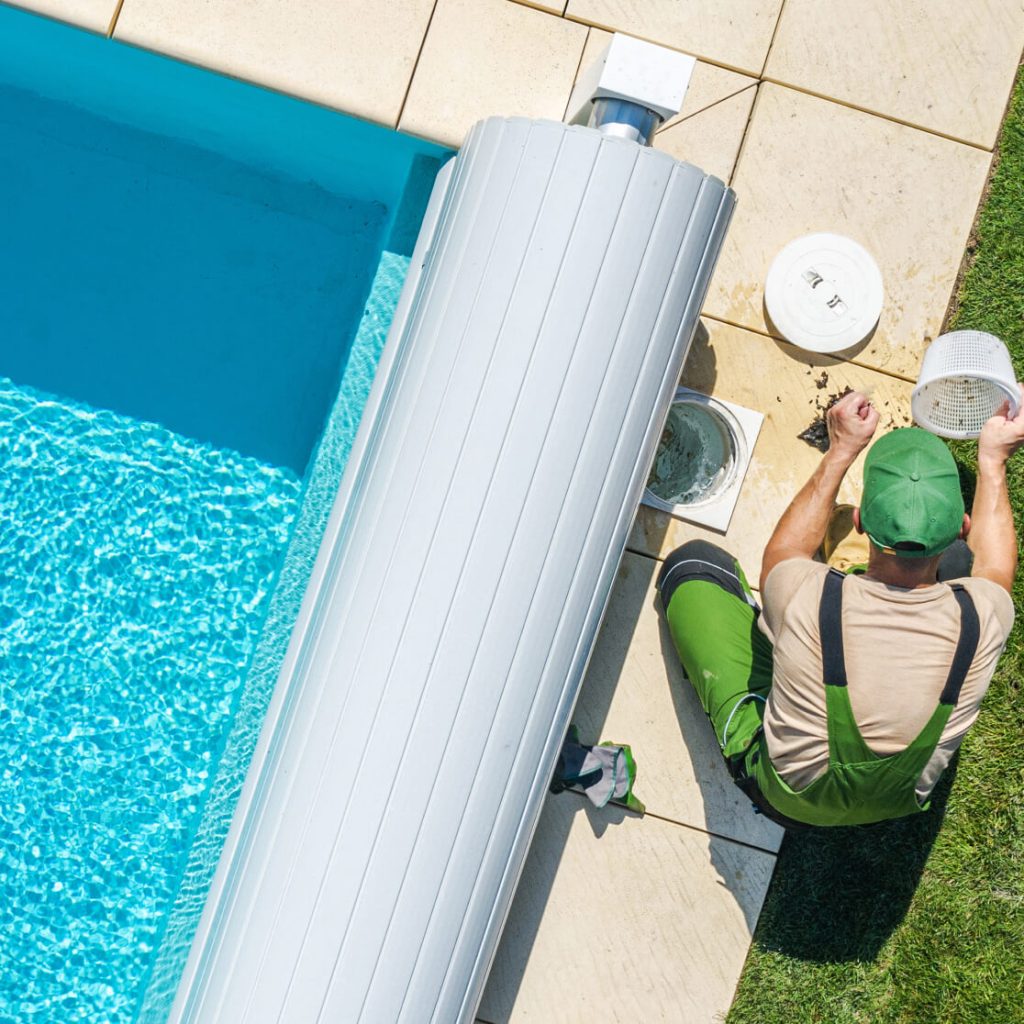 A pool technician maintaining a residential swimming pool